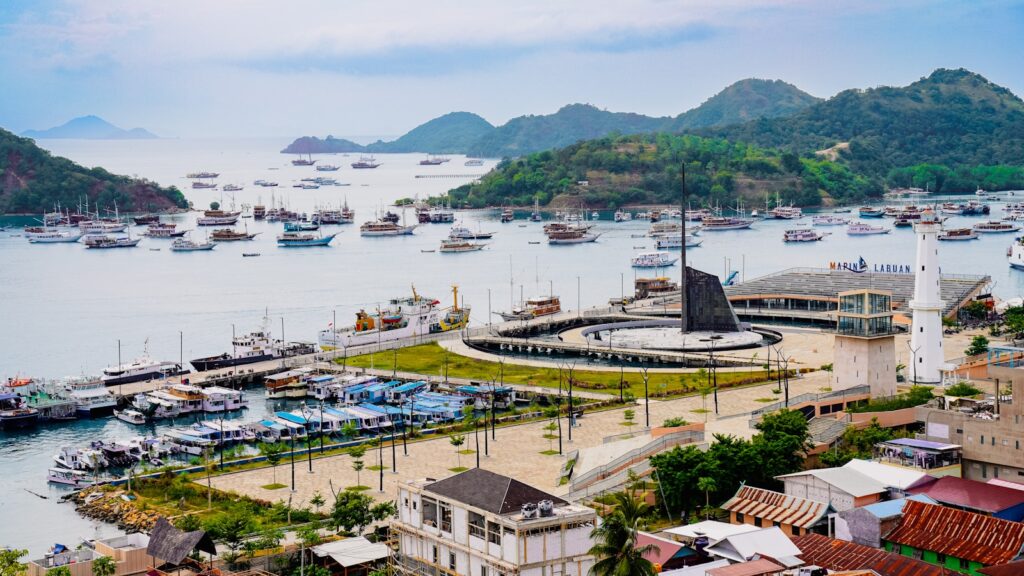 Boats docked in a bay with lush green hills.