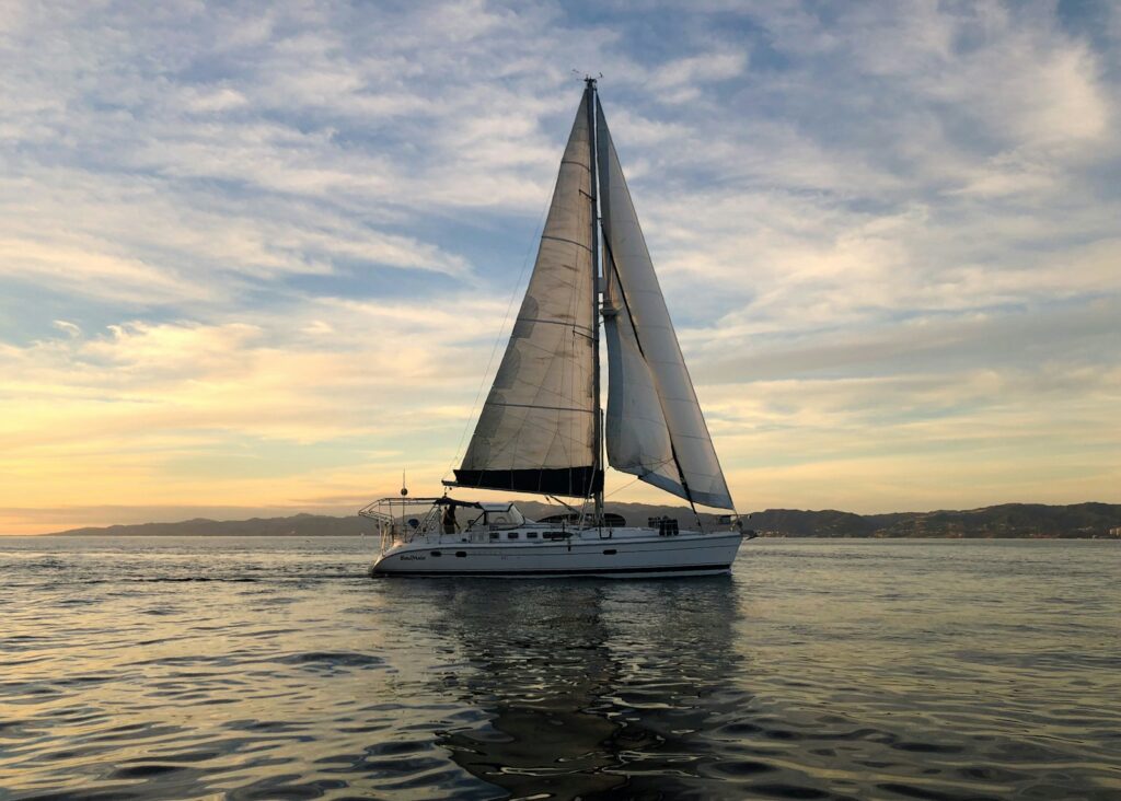 white sail boat on sea during daytime